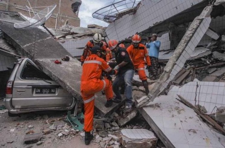 Petugas Basarnas membawa korban selamat gempa dan tsunami yang terjebak di dalam restoran Dunia Baru. (ANTARA FOTO/Muhammad Adimaja)